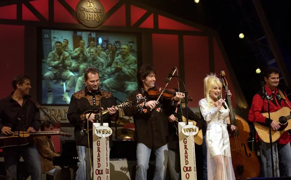 Dolly Parton singing with musicians during a 2005 Grand Ole Opry broadcast in Nashville.