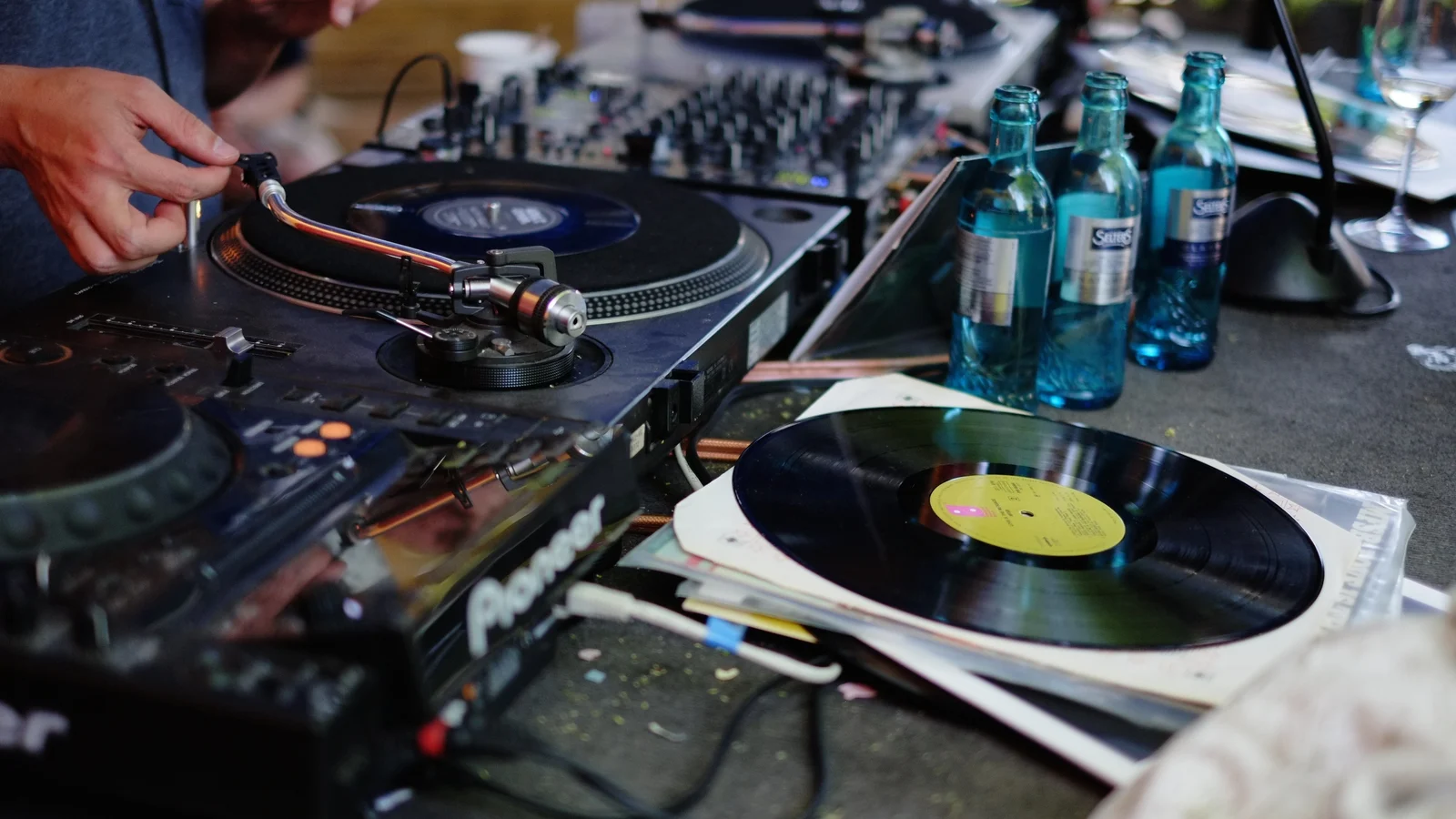 DJ putting on a vinyl record at a flea market in Frankfurt am Main, Germany.