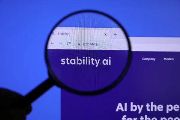 A computer screen showing the Stability AI logo, viewed through a magnifying glass in an archival 2023 photograph.